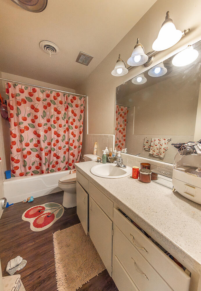 2412 33rd Street Lubbock, TX 79411 - Photo 29 of 34 a bathroom with a sink a large mirror and vanity