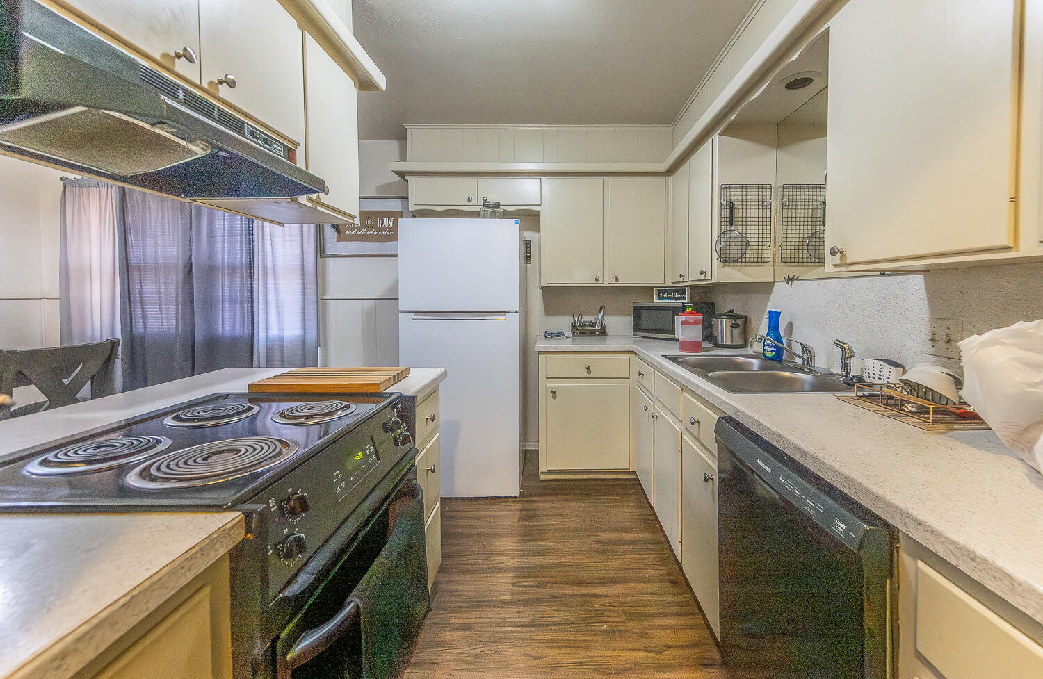 2412 33rd Street Lubbock, TX 79411 - Photo 3 of 34 a kitchen with a stove a sink and a refrigerator