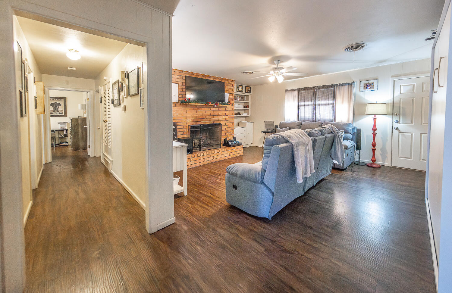 2412 33rd Street Lubbock, TX 79411 - Photo 4 of 34 a living room with fireplace furniture and a wooden floor