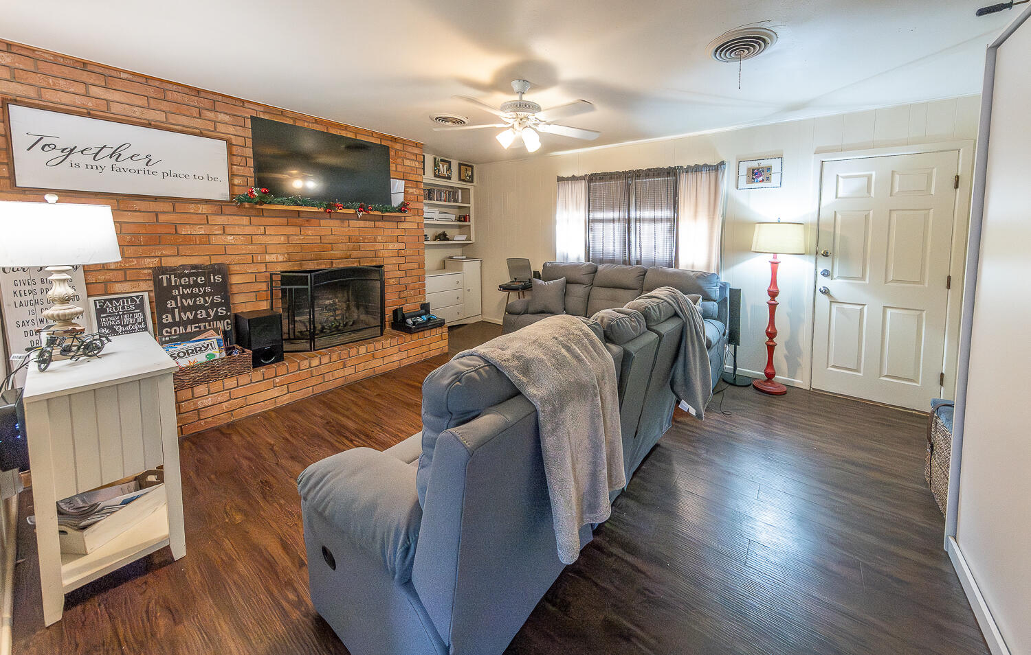 2412 33rd Street Lubbock, TX 79411 - Photo 5 of 34 a living room with furniture and a fireplace