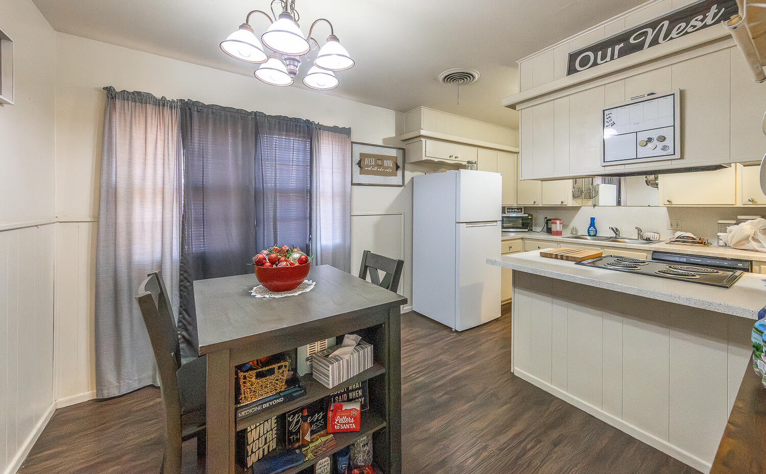 2412 33rd Street Lubbock, TX 79411 - Photo 7 of 34 a kitchen with stainless steel appliances granite countertop a refrigerator a stove and a dining table with wooden floor