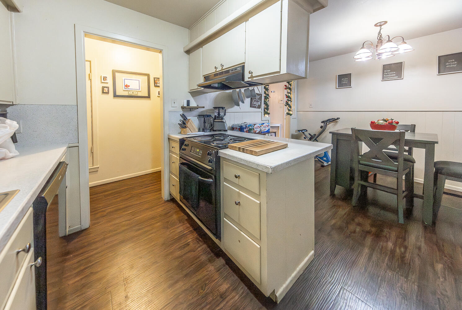 2412 33rd Street Lubbock, TX 79411 - Photo 10 of 34 a kitchen with a stove a refrigerator and wooden floor
