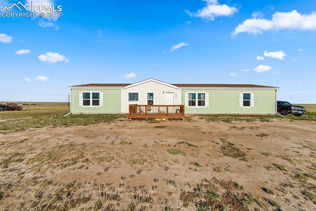 1305 North Ramah Highway Yoder, CO 80864 - Photo 1 of 30 a view of house with backyard and deck