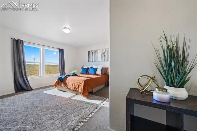 a bedroom with a bed and a potted plant