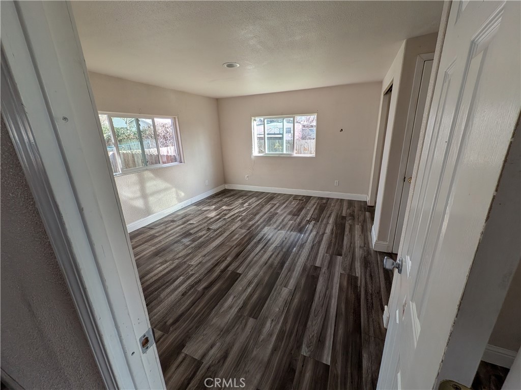 6029 1st Avenue Lucerne, CA 95458 - Photo 22 of 34 a view of wooden floor and windows in a room