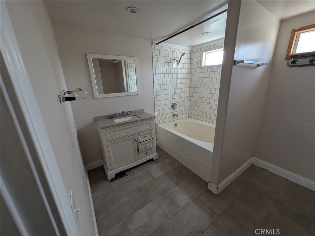 6029 1st Avenue Lucerne, CA 95458 - Photo 24 of 34 a bathroom with a tub sink and mirror