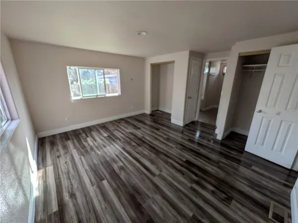 a view of a room with wooden floor