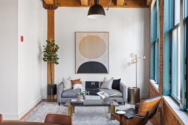 a living room with furniture and a potted plant