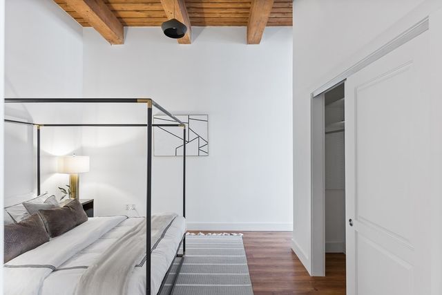 a bedroom with a bed and a mirror