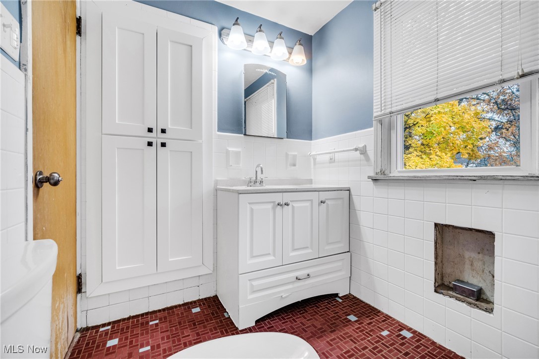 4430 Silsby Road Cleveland, OH 44118 - Photo 26 of 43 Bathroom featuring a tile fireplace, vanity, tile walls, and toilet