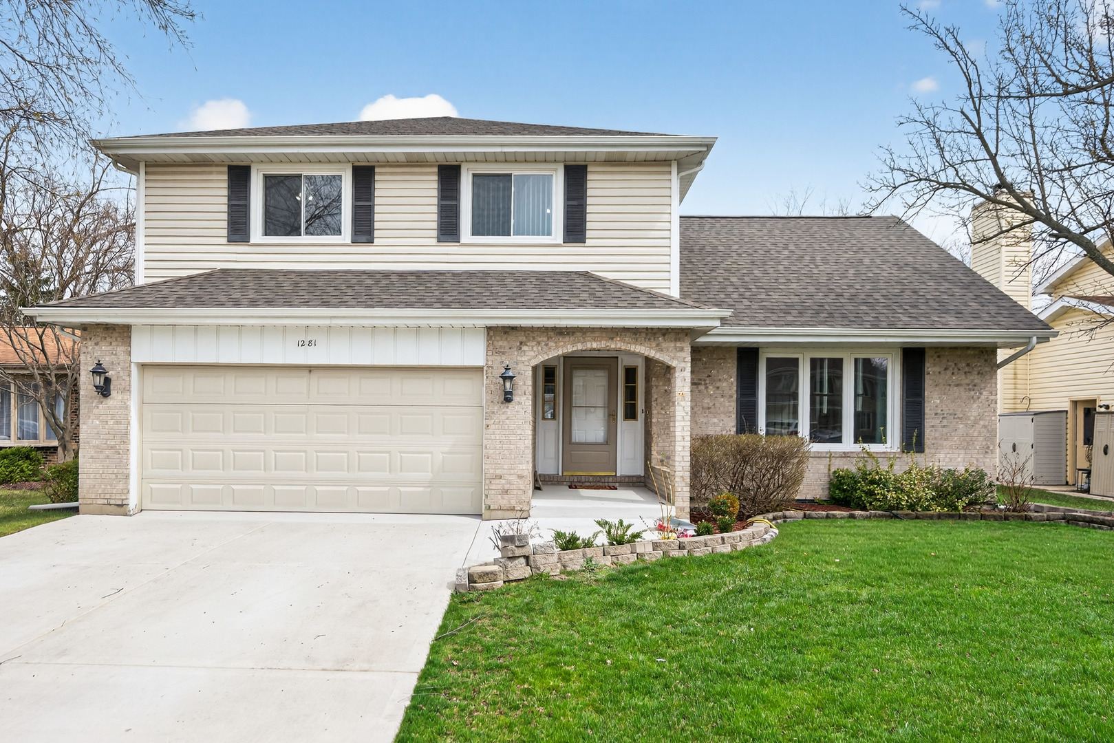 1281 Scarlet Drive Addison, IL 60101 - Photo 1 of 38 a front view of a house with a garden and yard
