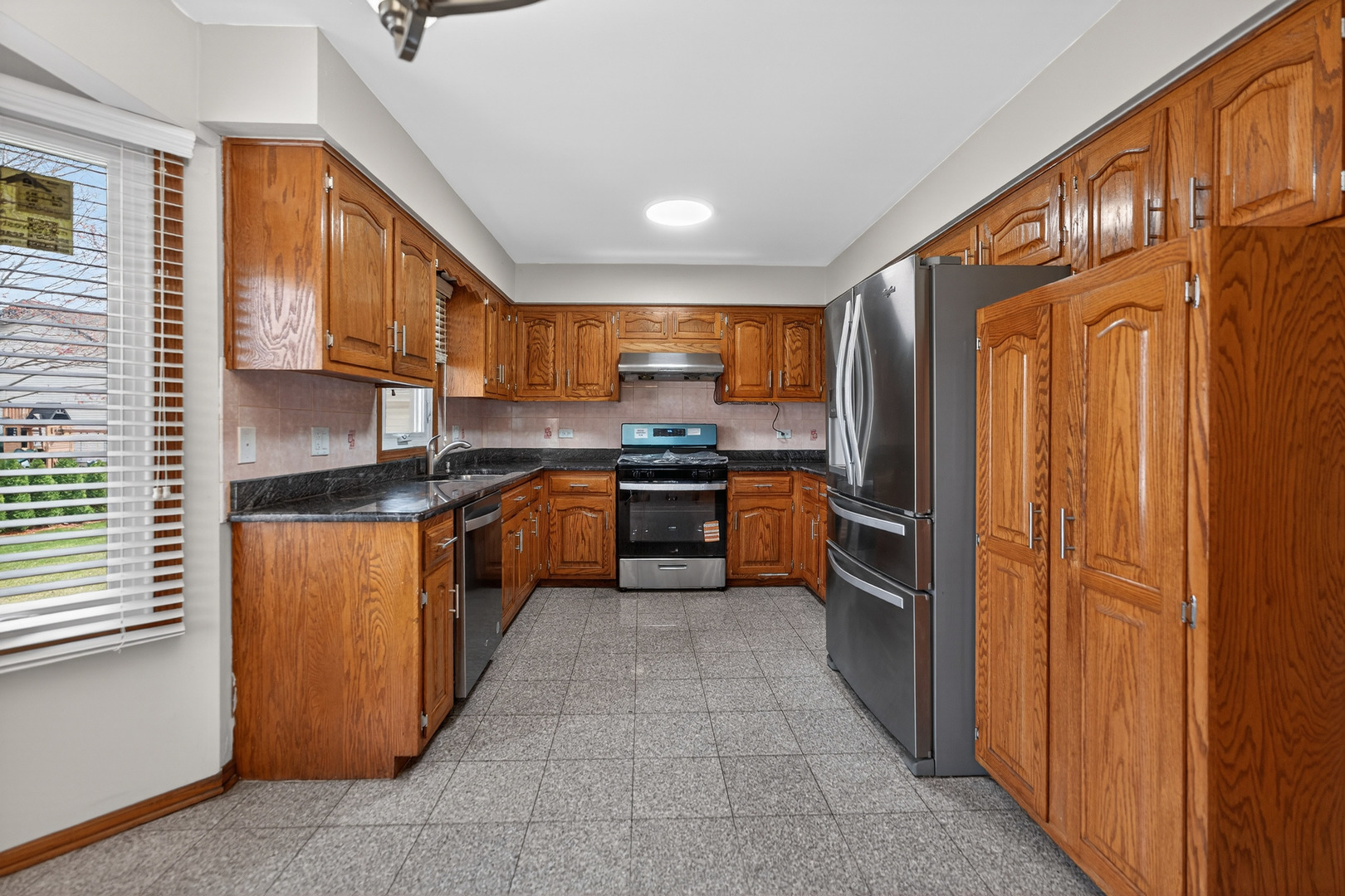 1281 Scarlet Drive Addison, IL 60101 - Photo 11 of 38 a kitchen with stainless steel appliances granite countertop a refrigerator a sink dishwasher a stove and a microwave oven with cabinets