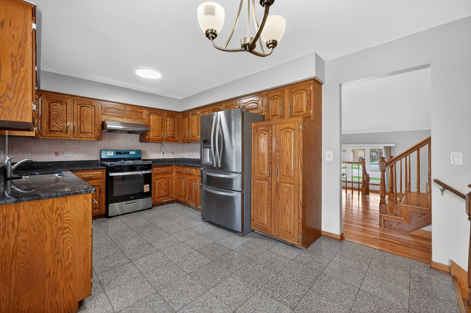 1281 Scarlet Drive Addison, IL 60101 - Photo 12 of 38 a kitchen with stainless steel appliances granite countertop a stove top oven a refrigerator a sink and dishwasher