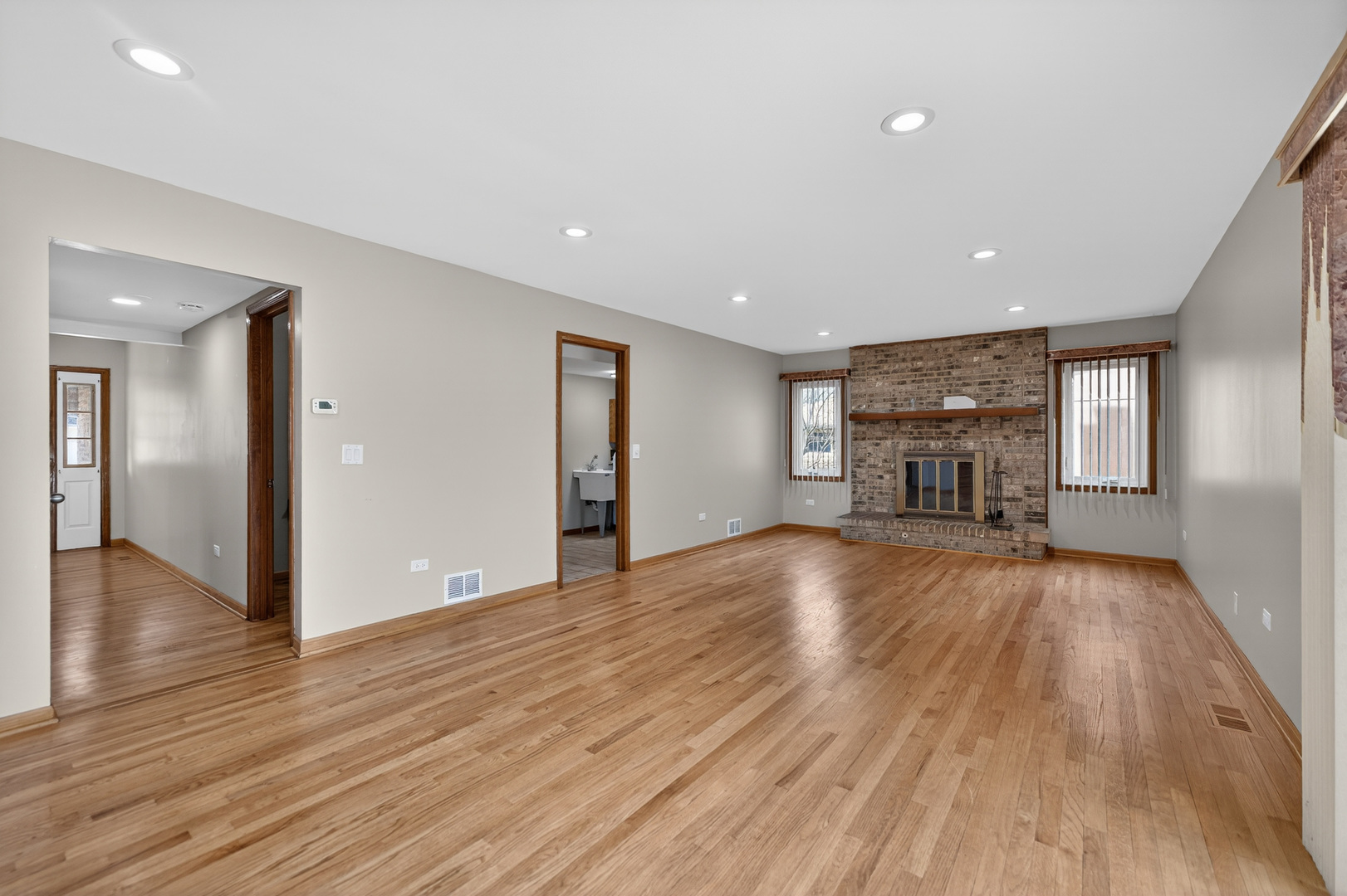 1281 Scarlet Drive Addison, IL 60101 - Photo 16 of 38 a view of empty room with wooden floor and fireplace
