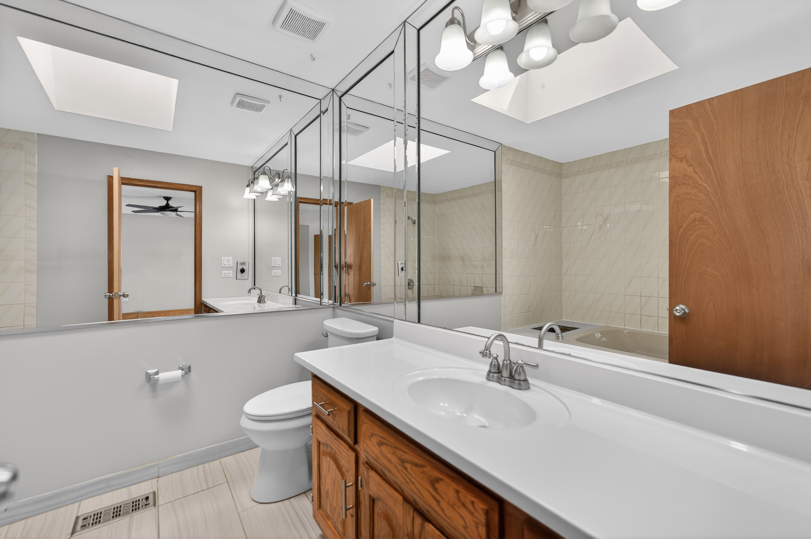 1281 Scarlet Drive Addison, IL 60101 - Photo 26 of 38 a bathroom with a sink a toilet and a large mirror