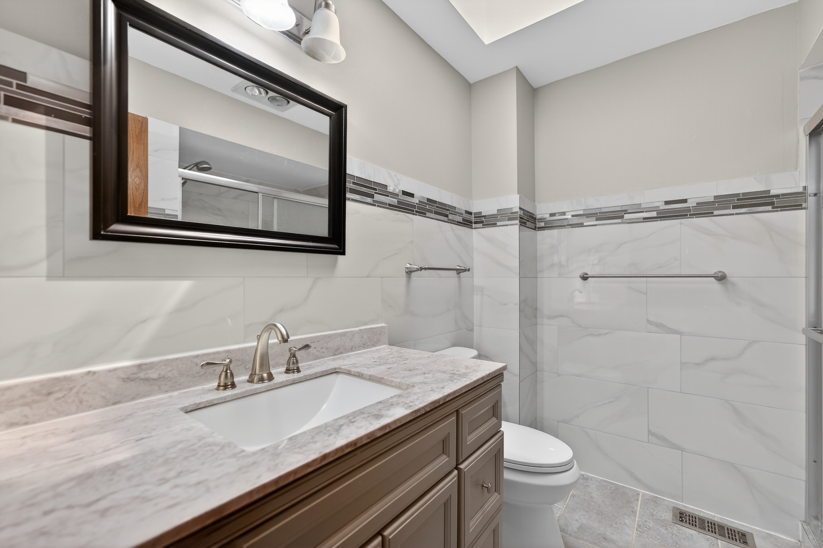 1281 Scarlet Drive Addison, IL 60101 - Photo 31 of 38 a bathroom with a granite countertop sink a toilet and a mirror