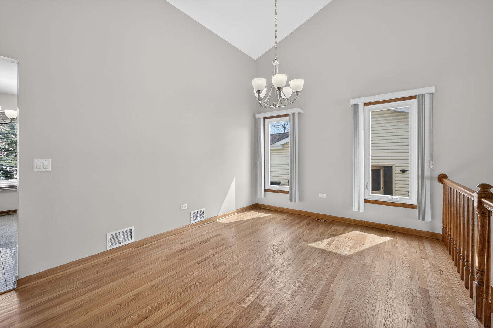 1281 Scarlet Drive Addison, IL 60101 - Photo 8 of 38 an empty room with wooden floor and windows