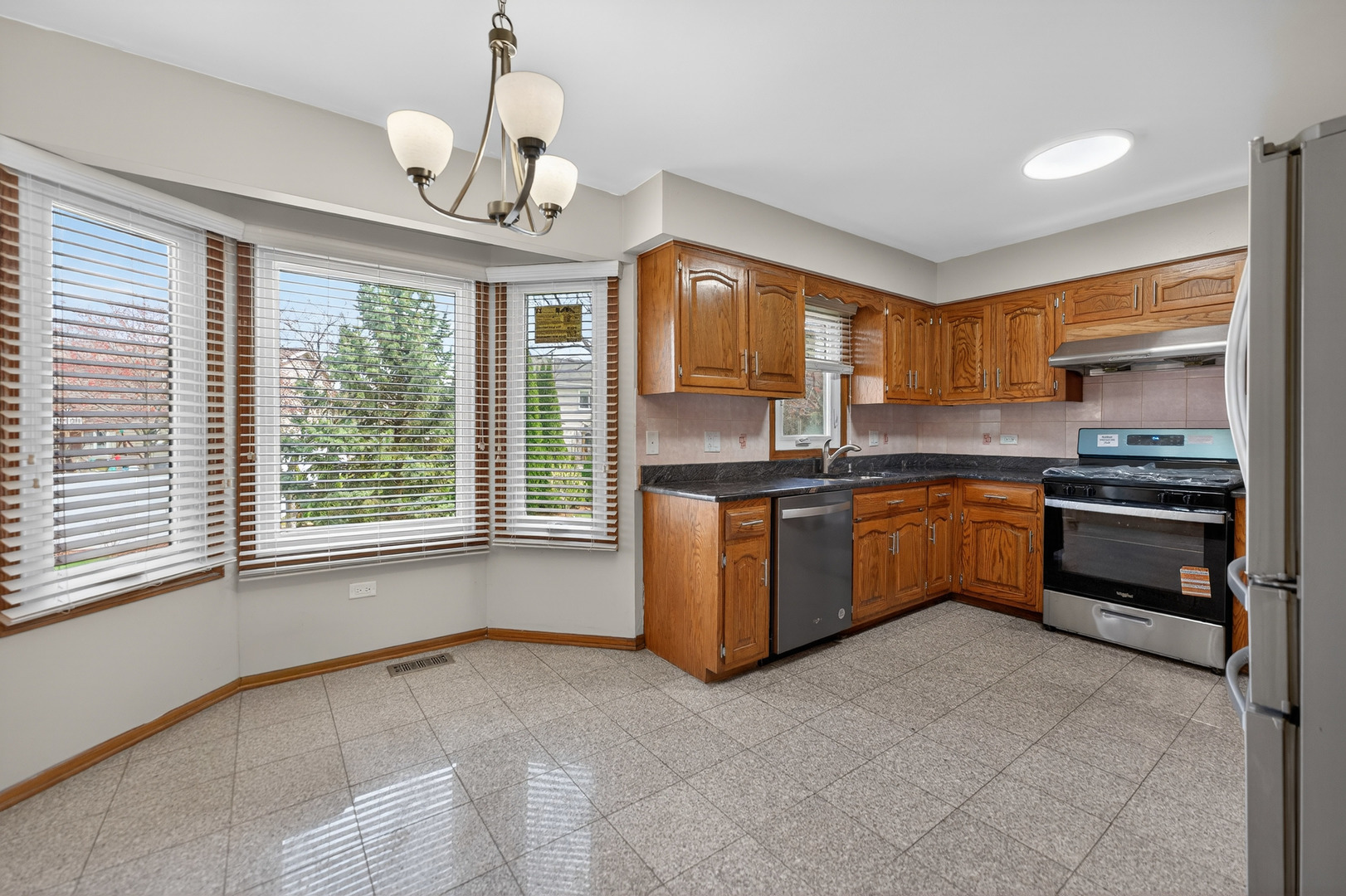 1281 Scarlet Drive Addison, IL 60101 - Photo 10 of 38 a kitchen with a stove a sink and a refrigerator