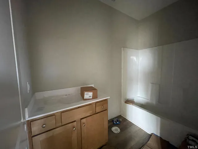 a bathroom with a glass shower door