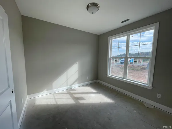 a view of a yard with wooden fence