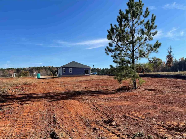 a view of house with backyard