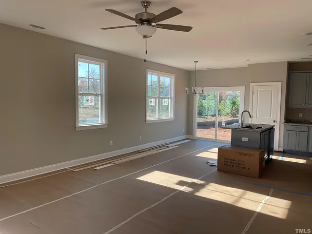 a view of a livingroom with a window and a ceiling fan