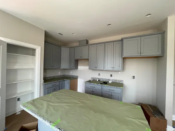 a kitchen with a sink cabinets and appliances