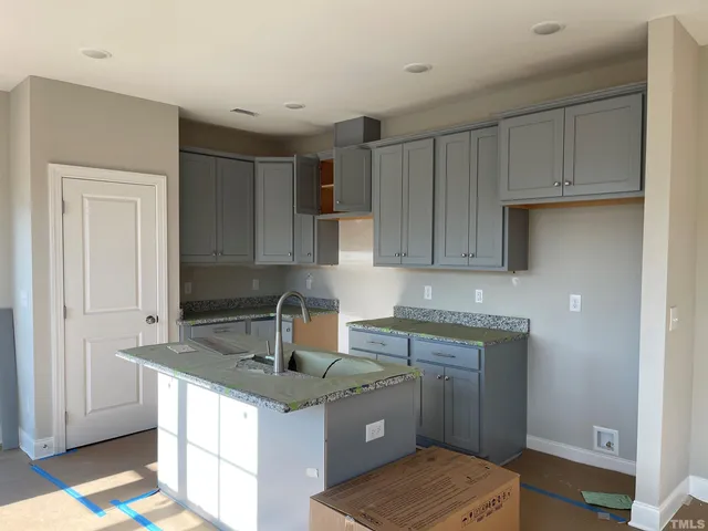 a kitchen with a stove a refrigerator and a wooden cabinets