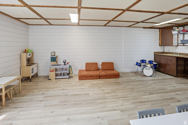 5108 South 2000th Street West Roy, UT 84067 - Photo 34 of 61 Playroom featuring light wood-style flooring and wooden walls