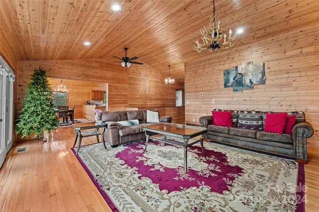 a living room with patio furniture and a chandelier