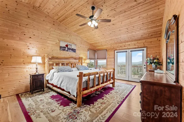 a bedroom with a bed a mirror and dresser