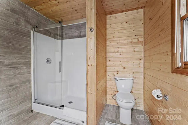 a bathroom with a toilet and a shower