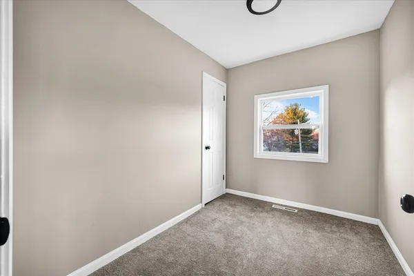 a view of an empty room with windows
