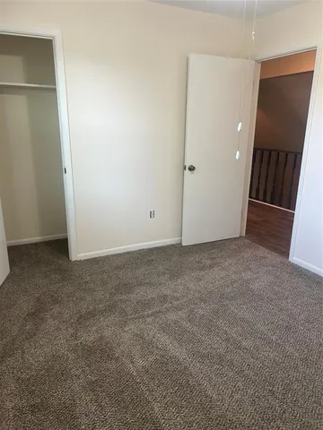 an empty room with closet and mirror