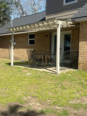 a yellow house sitting in middle of a yard