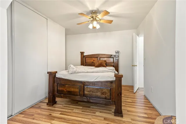 a bedroom with a bed and a ceiling fan