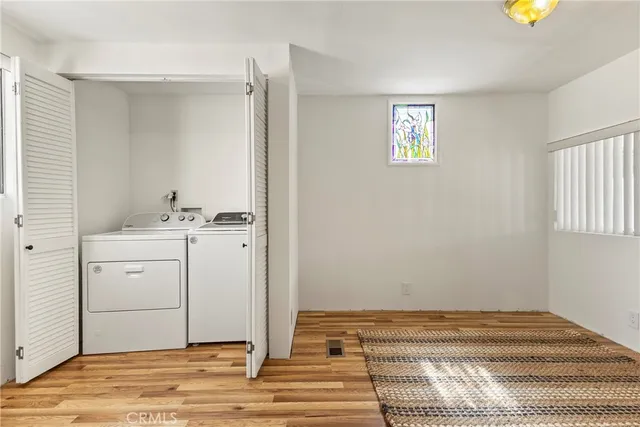 a view of a bedroom with a bed and a window