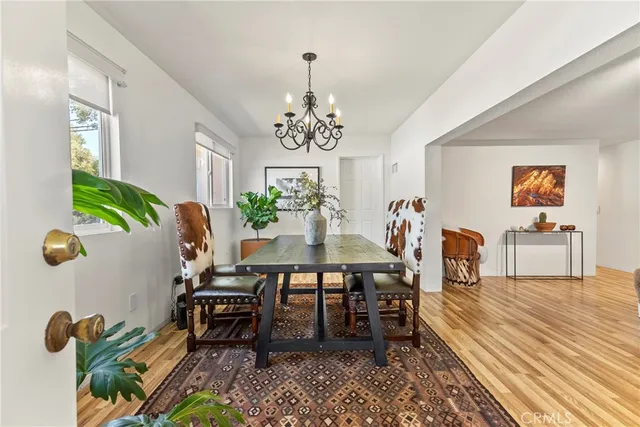 a view of a dining room with furniture and a potted plant