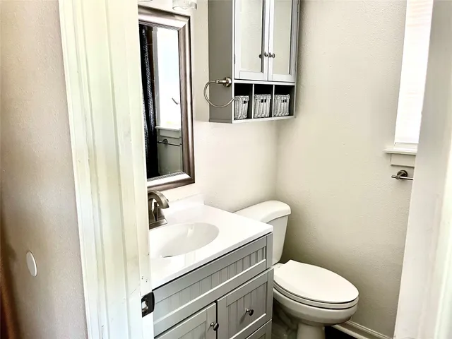 a white toilet sitting next to a bathroom sink