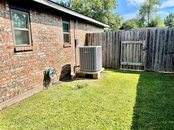 a view of backyard with small cabin and wooden fence