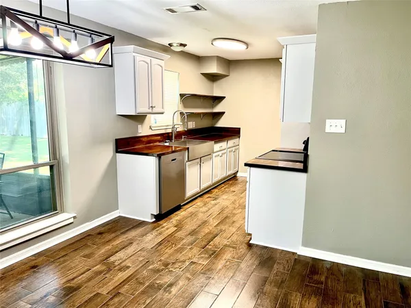 a kitchen with stainless steel appliances granite countertop a refrigerator and a stove