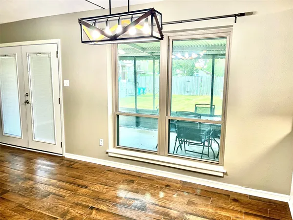 a view of a room with wooden floor and windows