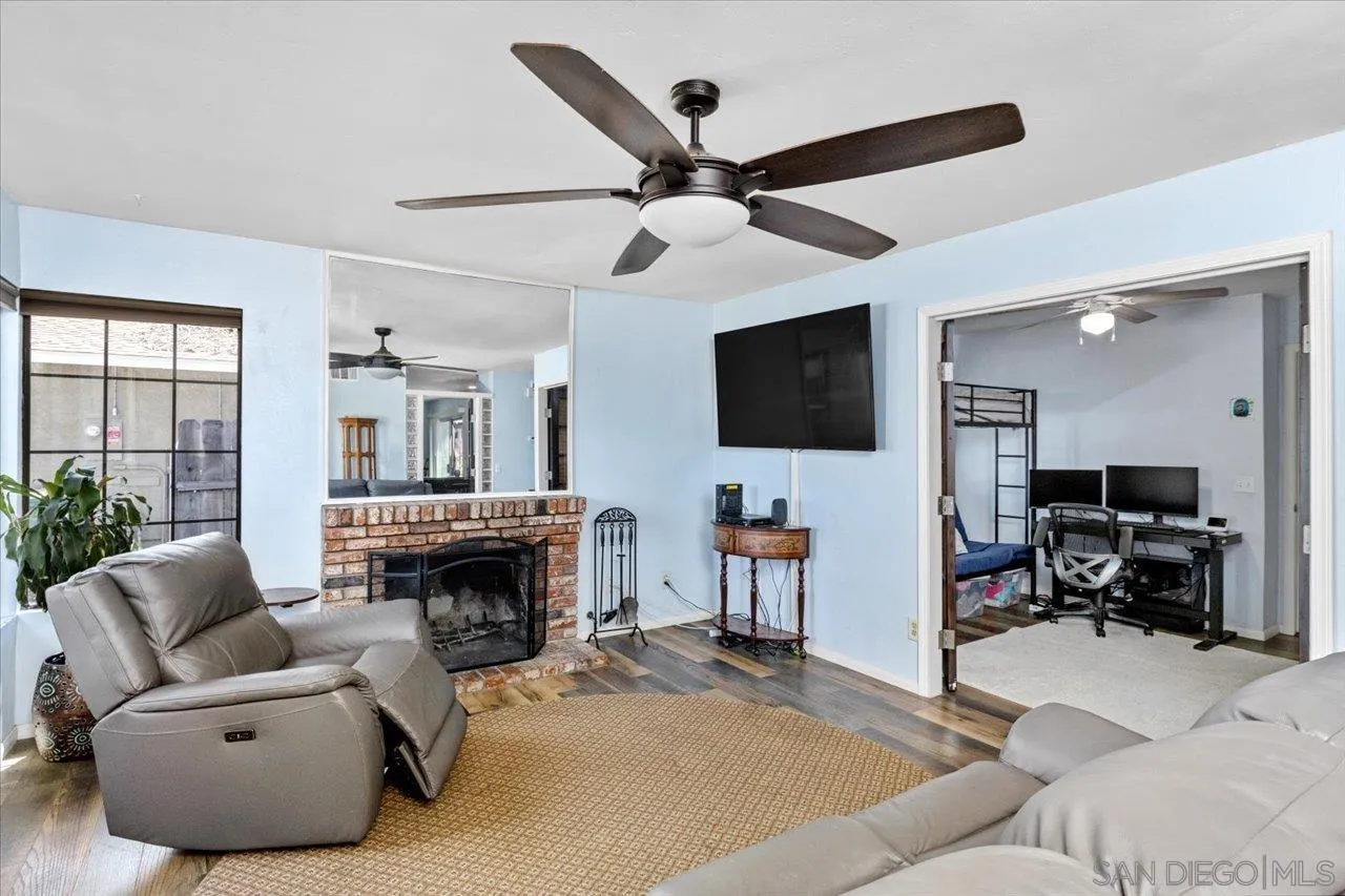 2337 Fallingleaf Road Oceanside, CA 92056 - Photo 14 of 34 a living room with furniture a fireplace and a flat screen tv
