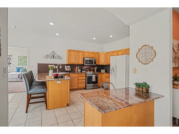 a living room with furniture and kitchen view
