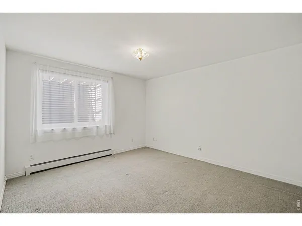 an empty room with a empty space and windows