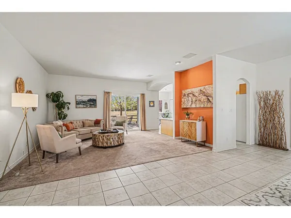 a living room with furniture and a open kitchen