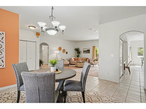 a view of a dining room with furniture and chandelier