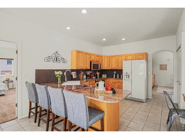 a dining room filled counter top space and stainless steel appliances