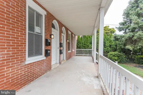 a view of a house with porch and wooden floor