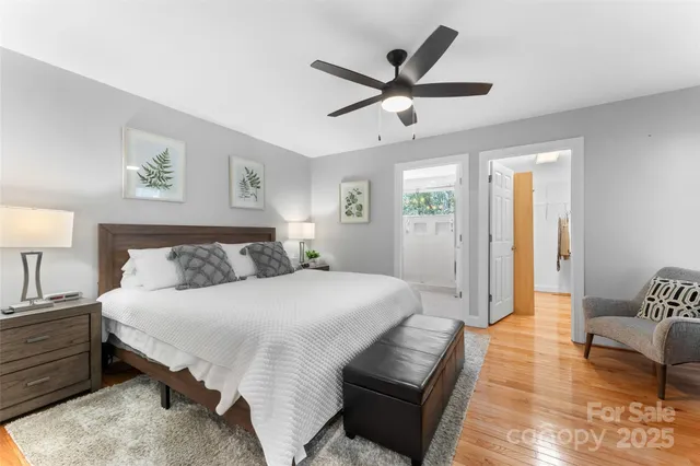 a spacious bedroom with a bed a couch and a window